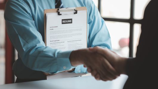 A person attends a job interview with a manager to join a company, he holds a resume and interview with information introducing himself and his ability to work. Job application concept.